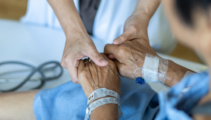 Holding hands with patient.