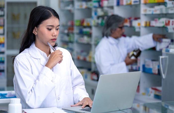 Pharmacist using tablet computer.